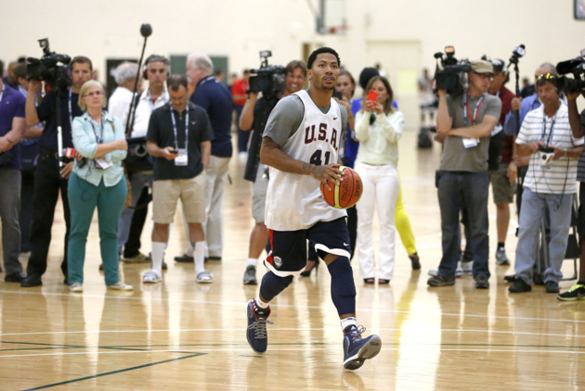 Reporters and photographers wait for Derrick Rose to finish his individual workout after a practice of the men's U.S. National basketball team in Chicago.